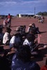 Men watch boys dancing. Children and adults celebrate the end of School