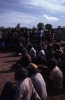 Men watch boys dancing. Children and adults celebrate the end of School