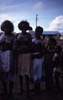 Sally Anne, Marjorie Gibson Nungarrayi (?), Roslyn Burns Nampijinpa, Sylvia Johnson Napanangka painted; Children and adults celebrate the end of School