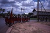 Lajamanu women march with the Aboriginal flag for NAIDOC