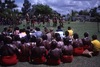 Lajamanu women watch Lajamanu men dancing Jurntu purlapa. Public performance for NAIDOC