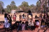 Women and kids dance in the park