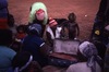 Nangala and Nampijinpa hold their ritual objects for NGAPA (water) in a suitcase: a red ochred dish.