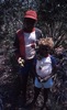 Two boys: young Gibson and Pana Jampijinpa (youngest) showing bush food