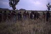 women walking near sacred hill long hill (yunta = windbreak) of Kurlungalinpa, country for Nungarrayi and Napaljarri