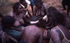 Women painted NGALYIPI with feather hairband 