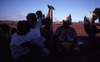 Women with Kuturru painted NGATIJIRRI (budgerigar) 