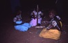 Women dance NGATIJIRRI (budgerigar) with yukurrukurru (women slates) in front of a kuturru (stick),